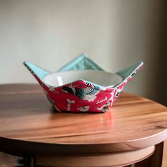 a paper boat sitting on top of a wooden table