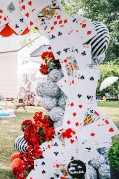 several cards are stacked on top of each other in front of a house and trees