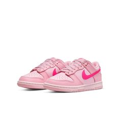 The Nike Dunk Low GS 'Triple Pink' is the ultimate representation of eye-catching style. The shoe offers full leather construction, which is brought to life with three distinct peppery shades of pink. The lightest shade provides the foundation for this cheerful design, with a slightly darker overlaying hue adding depth and detail. To make a bold statement, Nike branding swoops in with a vibrant pink Swoosh across both sides of the low-profile silhouette, complemented by further branding on sole, heel, tongue and inner sole. Grade School (GS) sizing adds further options for fashion-forward kids. Whether you're looking to complete an already aesthetically pleasing ensemble or just want something to brighten up your little one's day, the Nike Dunk Low GS 'Triple Pink' is sure to do the job. Nike Dunk Low Triple Pink, Pink Jordans, Boty Nike, Preppy Shoes, Pretty Shoes Sneakers, Nike Models, Different Shades Of Pink, Jordan 12 Retro, Cute Nike Shoes