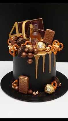 a cake with chocolates, candy and candies on it that says 40 years