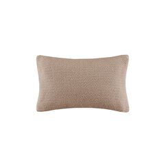 a beige pillow on a white background