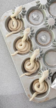 an image of cupcakes in the shape of animals on a tray with icing