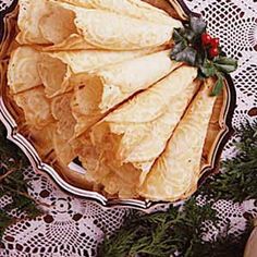 an image of some food on a plate with pine cones and holly wreaths around it