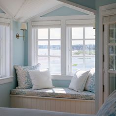 a window seat with pillows on it in a bedroom