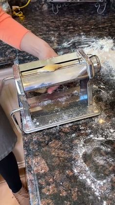 a person using a grater on top of a counter covered in flour and butter