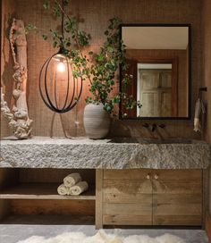 a bathroom with a sink, mirror and plants