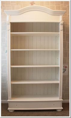 a white bookcase with three shelves on each side