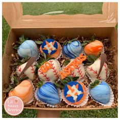 a box filled with different types of decorated cupcakes