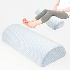 a woman sitting on top of a pillow with her feet propped up in the air