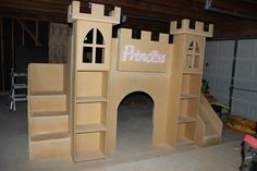 a cardboard castle made to look like it has stairs leading up to the front door