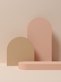 two pink and beige shapes on a white surface