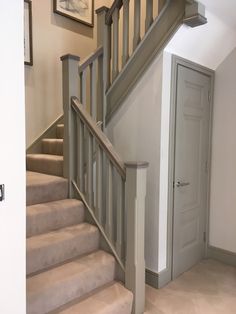 the stairs in this house are made of wood and have beige carpeting on them