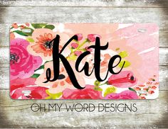 the name kate on a pink flowered license plate with black lettering that reads, oh my word designs