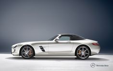 the mercedes sls amg roadster is shown in this studio photo taken at night