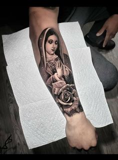 a woman with a rose tattoo on her leg is shown in black and grey colors