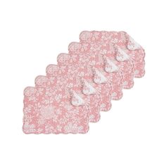 four pieces of pink and white placemats on a white background with floral designs