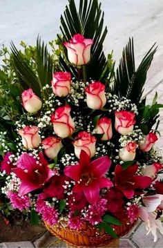 a basket filled with lots of pink and white flowers