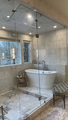 a bathroom with a large tub and walk in shower next to a sitting area on the floor