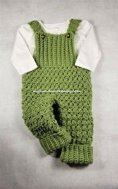 a green crocheted baby's outfit with white shirt