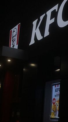 the kfc sign is lit up at night