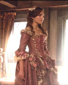 a woman dressed in an old fashion dress