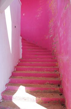 the stairs are painted bright pink and white