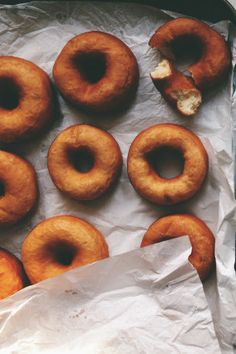 doughnuts sitting on top of a piece of wax paper