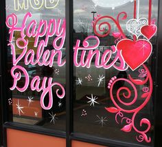 a window with the words happy valentine's day painted on it