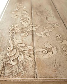 an old wooden table with carvings on it