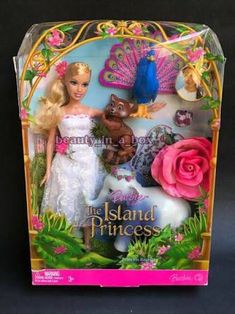 the barbie doll is in its box and has a pink rose on her head, as well as two other dolls