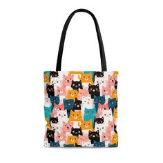 a multicolored cat pattern tote bag with black handles and two front pockets