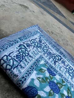 a blue and white cloth laying on the ground