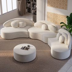 a living room filled with white furniture on top of carpet