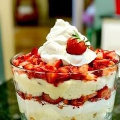 a trifle with strawberries and whipped cream on top