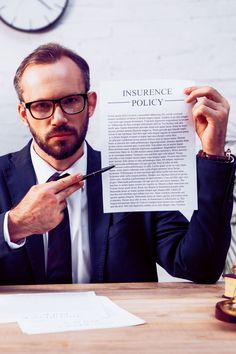 a man sitting at a table with a piece of paper in front of him