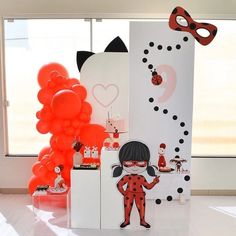 there are balloons and decorations in the room with ladybugs on them, including a refrigerator