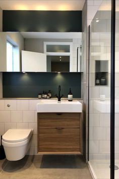 a bathroom with a sink, toilet and shower stall