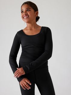 FOR: School, practice, and play FEEL: Seamless construction for maximum comfort and minimal chafing FAVE: Double layered fabric for added coverage Fitted next to the body Crop length, sits above the natural waist. Fitted Black Activewear, Bra Dress, Ribbed Crop Top, Summer Is Here, Swim Accessories, Free Fabric, Black Crop Tops, Jacket Tops, Top Shirt