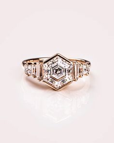 an antique diamond ring with three baguets in the center and four diamonds on each side