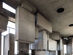 the interior of a building with concrete walls and flooring that has multiple square holes in it