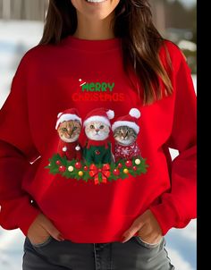 This adorable sweatshirt features funny cats dressed in Christmas sweaters and hats, perfect for the holiday festivities. It gives off a cozy and festive vibe, making it a great addition to anyone's winter wardrobe. Ideal for cat lovers and those who enjoy quirky holiday apparel. Product features - Knit in one piece without side seams for reduced fabric waste - Ribbed knit collar with seam for elasticity and shape retention - Made with a cozy medium-heavy fabric blend of 50% cotton and 50% polyester - Classic fit with crew neckline for a comfy wearing experience - Double-needle stitching for added durability Care instructions - Machine wash: cold (max 30C or 90F) - Non-chlorine: bleach as needed - Tumble dry: low heat - Do not iron - Do not dryclean Winter Cat Print Crew Neck Sweater, Winter Sweater With Cat Design, Red Cartoon Print Tops For Winter, Winter Crew Neck Top With Cat Print, Winter Long Sleeve Tops With Cat Print, Long Sleeve Cat Print Top For Winter, Long Sleeve Tops With Cat Print For Winter, Casual Christmas Sweatshirt With Cartoon Print, Cats In Sweaters