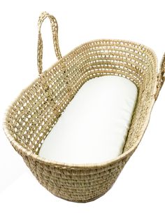 a wicker basket with a white cushion on the bottom and handles, sitting against a white background