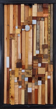 a piece of art made out of wood and measuring tape