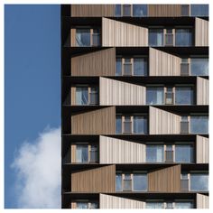 a tall building with lots of windows and balconies