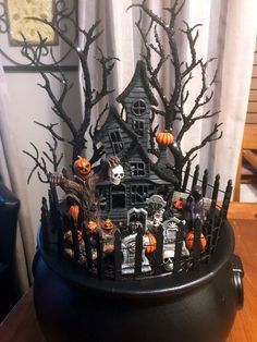 a black pot with halloween decorations on it