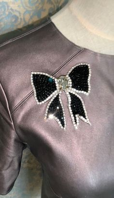 a close up of a dress with a bow on the back and sequins