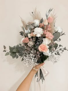 a person holding a bouquet of flowers in their hand