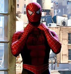 a spider man standing in front of a window