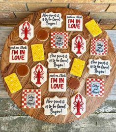 decorated cookies on a wooden platter with sayings