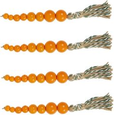 three orange beads are tied together with twine